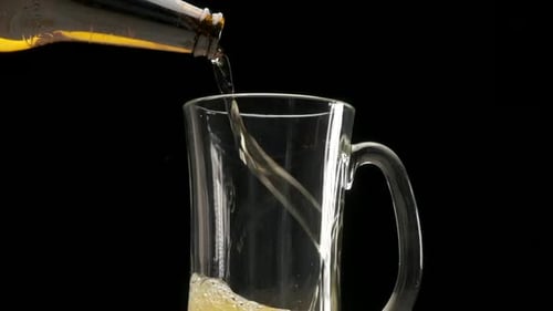 Beer Pouring into a Clear Glass Mug