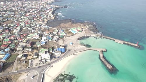 Scenery of the beach which has emerald color on its water. Other side of the beach, there are lots o