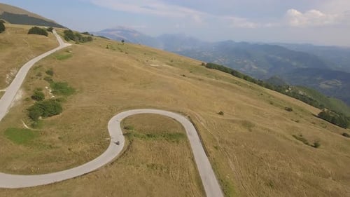 Aerial view of a man driving a motorbike on a mountain road