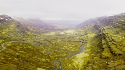 Beautiful Aerial Shot of Lush Mountain With a Narrow River at the Center
