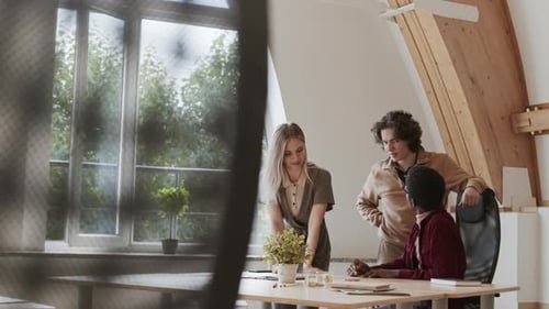 Team Collaborates in Bright Modern Workplace Office