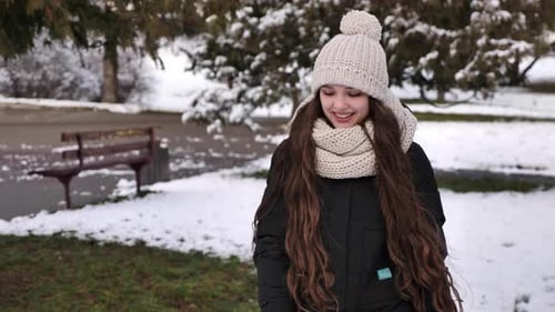 Happy woman walks in the winter forest