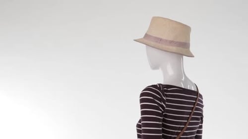 Mannequin Wearing Striped Shirt, Hat, and Bag