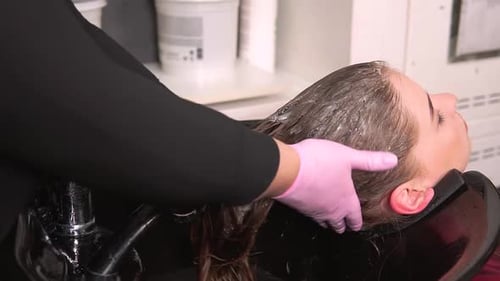 Woman Getting Hair Washed at a Cosmetology Salon