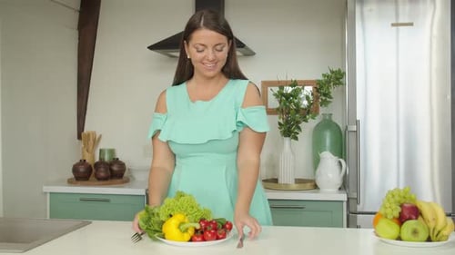 Woman Sampling Colorful Salad in Bright Kitchen