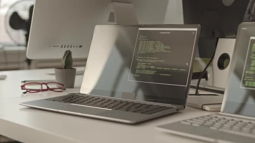 Laptop Displaying Source Code in Modern Office