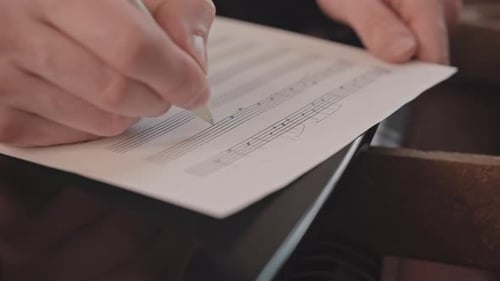 Musician Composes Sheet Music with White Pen