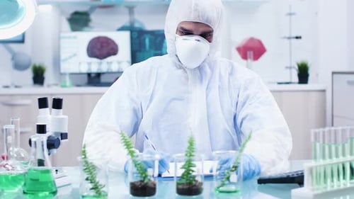 Scientist Examining Plant Specimens in Modern Laboratory