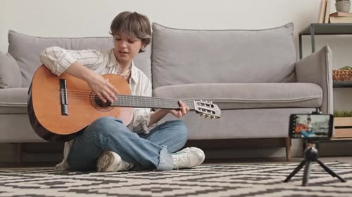 Young Adult Playing Guitar For Streaming Video