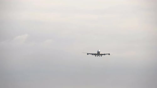 Plane Approaches Runway in Overcast Sky