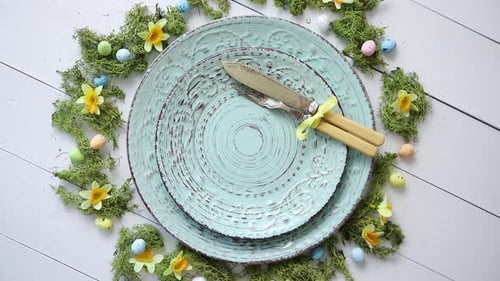 Easter Table Setting with Plates, Eggs, Flowers