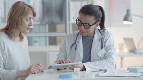 Friendly Doctor Discussing Results With Patient in Office