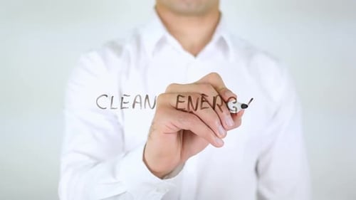 Man Writes Clean Energy on Clear Surface