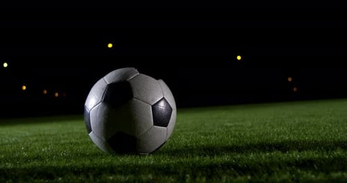 Soccer Ball Kicked at Night on Field
