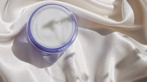 Cream Container on White Satin
