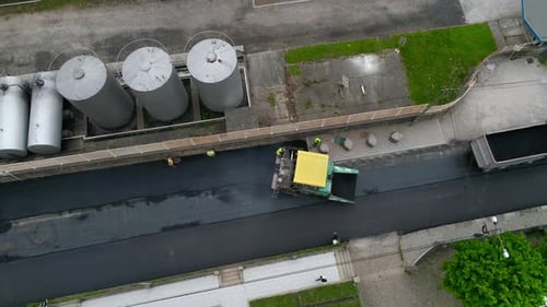 Road Paver Laying Asphalt From Aerial View
