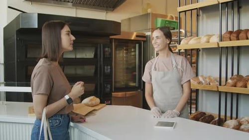 Bakery Counter Attendant Talking to Customer