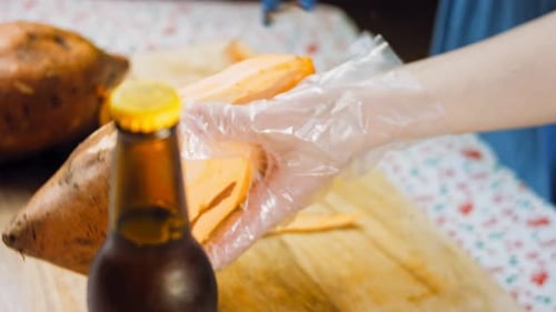 Close Up of Someone Peeling a Sweet Potato
