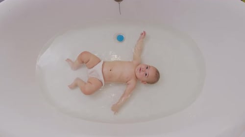 Baby Close Up Playing in Bath