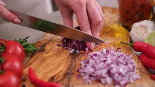 Hands Dice Red Onion on Cutting Board