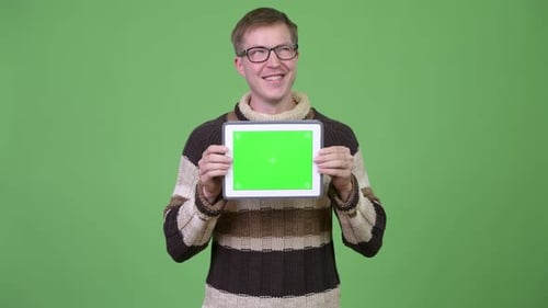 Young Adult Holding Tablet Against Green Screen