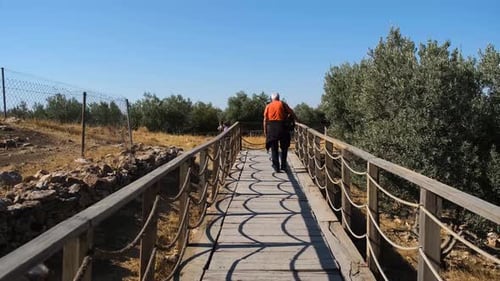Man Walking on Suspension Bridge