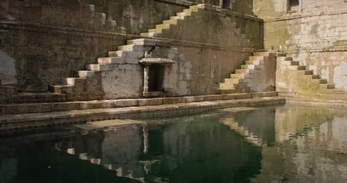 Ancient Stone Stepwell Reflecting in Still Water