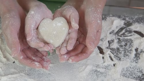 Heart cookies in the hands. A child hold a heart cookies.