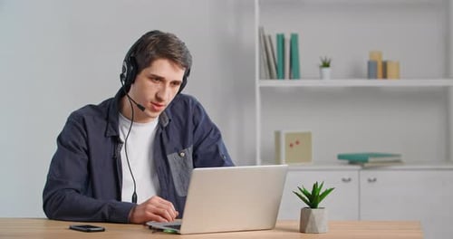 Man Talking on a Video Call Using a Laptop
