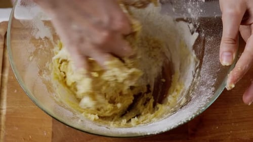 Hands Kneading Dough in Bowl for Baking