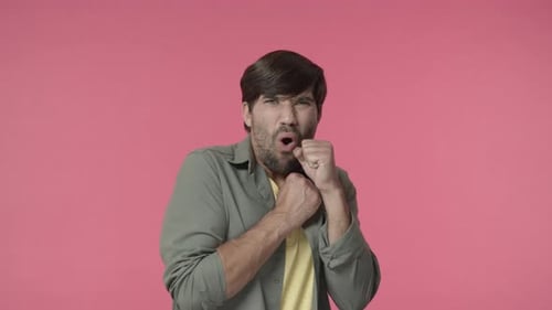 Man Coughing into Fist, Displaying Cold Symptoms