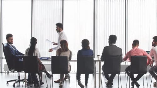 Diverse Team Attends Conference Meeting with Presentation