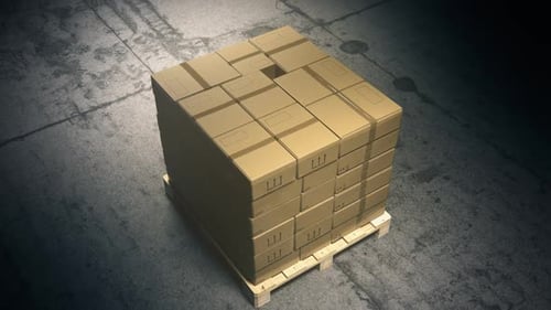 A stack of cardboard boxes on a pallet in the warehouse waiting for a forklift.