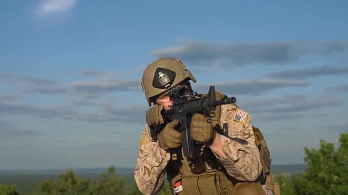 Slow Motion. Man in Military Uniform with a Gun Shooting.