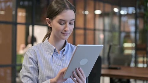 Woman Using Tablet in Modern Office Setting