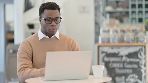 Young Adult Participating in a Video Call at Cafe