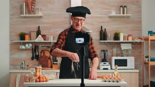 Chef Sprinkles Flour on Countertop in Kitchen