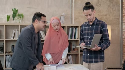 A group of Muslim startup team discussions in a small office.