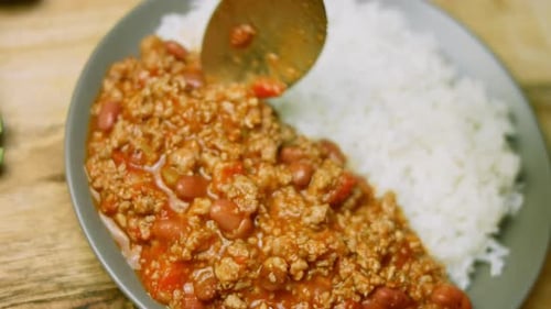 Chili Con Carne Being Served Over Rice