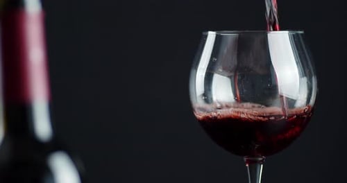 Pouring Red Wine into a Glass