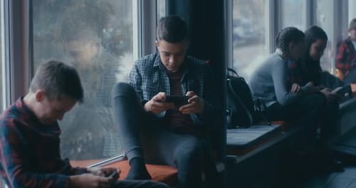 Kids Playing on Their Smartphone in School