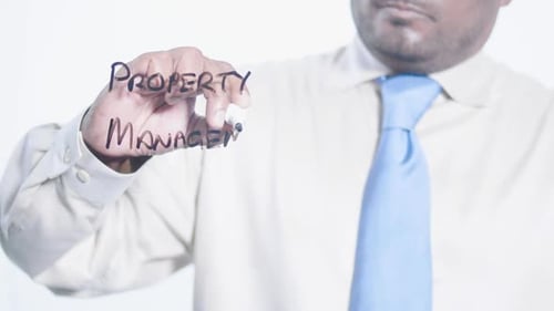 Man Writes Property Management with Marker