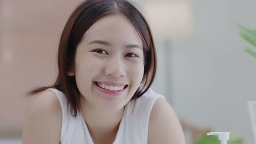 Smiling Young Adult Woman Looking at Camera