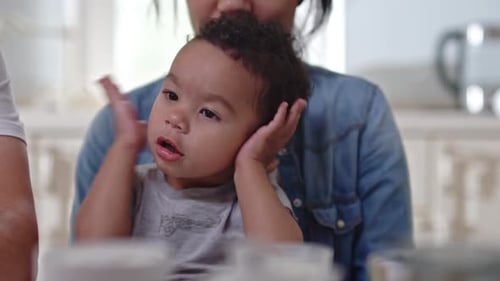 Toddler Laughing While Being Held by an Adult