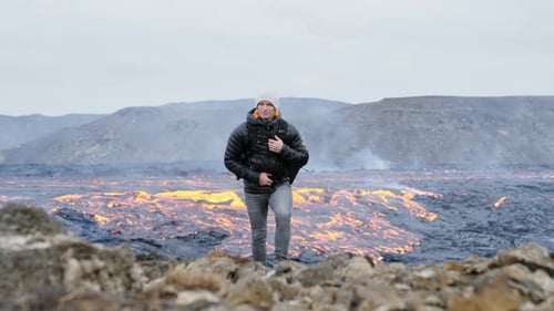 Man Walking Across Volcanic Landscape