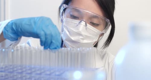 Scientist Examining Blue Liquid in Test Tube