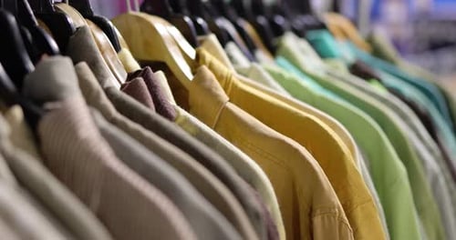 Close up cloth and dress hanging with rack in mall shop or cloth store.
