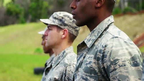 Soldiers Standing at Attention in Outdoor Setting