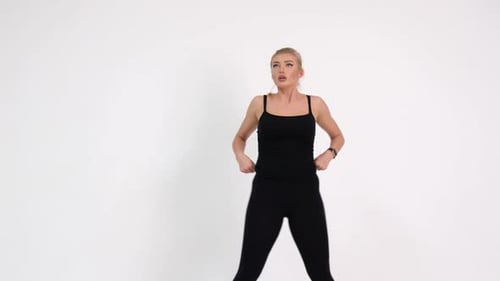 Sexy girl doing fitness exercises. Shooting in the studio on a white background