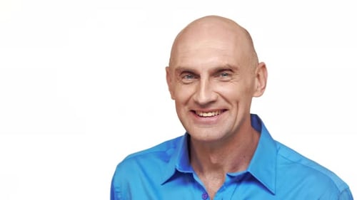 Smiling Bald Man in Blue Shirt Close Up